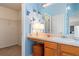 Bright bathroom with a vanity, sink, mirror, cabinets, and walk-in closet at 726 Fir Chase, Fairburn, GA 30213