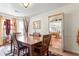 Cozy dining room featuring a spacious table, window views, and access to the kitchen at 726 Fir Chase, Fairburn, GA 30213