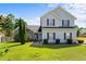 Charming two-story home featuring landscaped yard, red shutters, and a combination of siding and stone facade at 726 Fir Chase, Fairburn, GA 30213