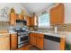 Updated kitchen features stainless appliances, tile backsplash, and stylish fixtures at 726 Fir Chase, Fairburn, GA 30213