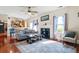 Inviting living room features a cozy fireplace, ceiling fan, and gleaming hardwood floors at 726 Fir Chase, Fairburn, GA 30213