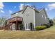 Exterior view showcases a backyard with a wooden deck, white doors, and well-maintained green lawn at 902 Brumley Nw Ln, Kennesaw, GA 30152