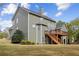 Spacious backyard featuring a large deck with stairs and lush green lawn under a partly cloudy sky at 902 Brumley Nw Ln, Kennesaw, GA 30152