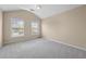 Neutral bedroom with vaulted ceiling, carpet, and natural light from the windows at 902 Brumley Nw Ln, Kennesaw, GA 30152