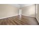 Spacious main bedroom with hardwood floors, a trey ceiling, and double doors to the ensuite bathroom at 902 Brumley Nw Ln, Kennesaw, GA 30152