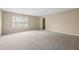 Spacious bedroom with neutral walls, plush carpeting, and a walk-in closet at 902 Brumley Nw Ln, Kennesaw, GA 30152
