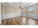 Elegant dining room with hardwood floors, a chandelier, and classic wainscoting details at 902 Brumley Nw Ln, Kennesaw, GA 30152