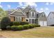 Charming two-story home with a manicured lawn and a two-car garage and stone detailing at 902 Brumley Nw Ln, Kennesaw, GA 30152