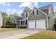 Charming two-story home with a manicured lawn and a two-car garage and stone detailing at 902 Brumley Nw Ln, Kennesaw, GA 30152