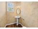 Cozy half bathroom featuring a pedestal sink and decorative wallpaper design at 902 Brumley Nw Ln, Kennesaw, GA 30152