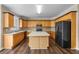 Spacious kitchen featuring an island, wooden cabinets, and modern appliances at 902 Brumley Nw Ln, Kennesaw, GA 30152