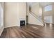 Spacious living room with hardwood floors, a fireplace, and tall windows offering ample light at 902 Brumley Nw Ln, Kennesaw, GA 30152