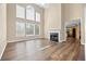 Spacious living room with hardwood floors, a fireplace, and tall windows offering ample light at 902 Brumley Nw Ln, Kennesaw, GA 30152