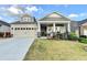 Charming home with a well-maintained front lawn and a welcoming front porch with classic columns at 230 Hickory Chase, Canton, GA 30115