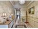 Hallway with neutral colors, trim, and a decorative chandelier leading into other rooms at 230 Hickory Chase, Canton, GA 30115