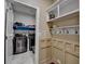 Convenient laundry room featuring modern washer and dryer, useful shelving and stylish hooks on the wall at 230 Hickory Chase, Canton, GA 30115