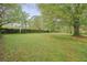 Lush backyard with mature trees and green lawn, offering a serene outdoor space at 2449 Fraser Rd, Marietta, GA 30066
