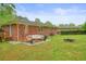 Backyard with patio, seating, grill, and brick house with string lights at 2449 Fraser Rd, Marietta, GA 30066