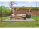 Brick house backyard features patio, ample seating, lush grassy area, and string lights at 2449 Fraser Rd, Marietta, GA 30066