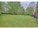 Large backyard with patio area, outdoor seating, and grassy area that extends far back at 2449 Fraser Rd, Marietta, GA 30066