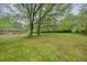 Spacious backyard with mature trees and a well-kept lawn, perfect for outdoor activities at 2449 Fraser Rd, Marietta, GA 30066