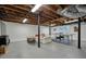 Large basement with exposed ceiling, ping pong table, and white furniture at 2449 Fraser Rd, Marietta, GA 30066