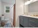 Bathroom with hexagon tile flooring, blue vanity, and subway tiled shower/tub combo at 2449 Fraser Rd, Marietta, GA 30066