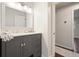 Bathroom with custom vanity, large framed mirror, and door to adjacent room at 2449 Fraser Rd, Marietta, GA 30066