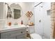 Bathroom features round mirror, tile shower, decor, and gray vanity at 2449 Fraser Rd, Marietta, GA 30066