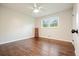 Light and airy bedroom with hardwood floors, ceiling fan, window, and white walls at 2449 Fraser Rd, Marietta, GA 30066