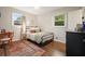 Cozy bedroom features wood floors, two windows, and furniture at 2449 Fraser Rd, Marietta, GA 30066
