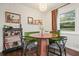 Bright dining nook featuring a round wood table, open window, bar and seating area at 2449 Fraser Rd, Marietta, GA 30066