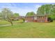 Well-maintained brick home with a spacious front lawn and mature landscaping at 2449 Fraser Rd, Marietta, GA 30066