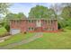 Traditional brick home with a well-maintained lawn and mature trees at 2449 Fraser Rd, Marietta, GA 30066