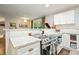 Updated kitchen with white cabinets, granite countertops, stainless steel appliances, and wood flooring at 2449 Fraser Rd, Marietta, GA 30066