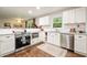 Eat-in kitchen area with stainless steel appliances, granite countertops, tile backsplash, and wood flooring at 2449 Fraser Rd, Marietta, GA 30066