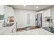 Bright kitchen featuring stainless steel appliances, granite countertops, white cabinets, and dark wood flooring at 2449 Fraser Rd, Marietta, GA 30066