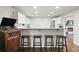 Open kitchen with breakfast bar and seating overlooks the living space and fireplace, great for entertaining at 2449 Fraser Rd, Marietta, GA 30066