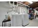 This laundry room features a washer, dryer, and overhead pipes at 2449 Fraser Rd, Marietta, GA 30066