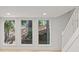 Basement view with large windows overlooking greenery and a staircase at 330 Spring Lake Ter, Roswell, GA 30076