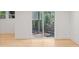 Basement view with sliding glass doors leading to outdoor space and light wood flooring at 330 Spring Lake Ter, Roswell, GA 30076