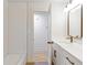 Cozy bathroom featuring white subway tile in tub and shower, modern finishes, and an open doorway at 330 Spring Lake Ter, Roswell, GA 30076