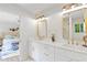 Bright and elegant bathroom featuring double sinks, and a view into the main bedroom at 330 Spring Lake Ter, Roswell, GA 30076
