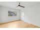 Modern bedroom with hardwood flooring, a ceiling fan, and backyard view at 330 Spring Lake Ter, Roswell, GA 30076