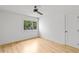 Modern bedroom featuring hardwood floors, a ceiling fan, and a view of the backyard at 330 Spring Lake Ter, Roswell, GA 30076