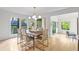 Bright dining area with a modern chandelier, wood floors and view into an additional seating area at 330 Spring Lake Ter, Roswell, GA 30076