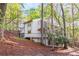 View of the house surrounded by trees and natural landscaping at 330 Spring Lake Ter, Roswell, GA 30076