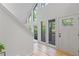 Bright and modern foyer featuring hardwood floors and tall windows at 330 Spring Lake Ter, Roswell, GA 30076