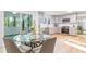 Eat-in kitchen with updated appliances, light-colored cabinetry, and a glass table with seating at 330 Spring Lake Ter, Roswell, GA 30076