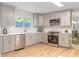 Well-lit kitchen featuring modern cabinetry, stainless steel appliances, and a window with a view at 330 Spring Lake Ter, Roswell, GA 30076